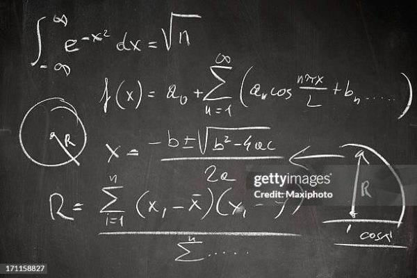 Complicated math formula written on a blackboard with white chalk