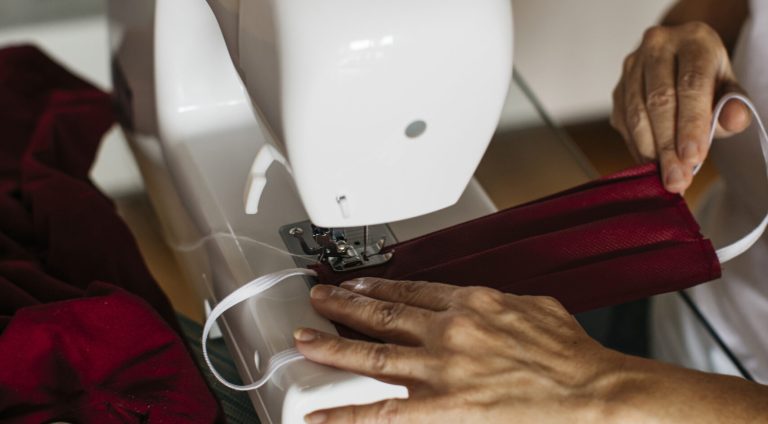 Hands of a woman sewing face masks