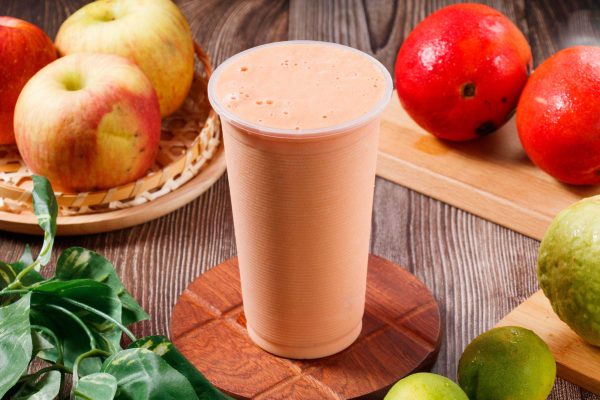 Fresh papaya milk with raw fruits served in glass isolated on table top view of morning vitamins drink
