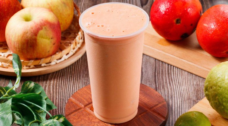 Fresh papaya milk with raw fruits served in glass isolated on table top view of morning vitamins drink