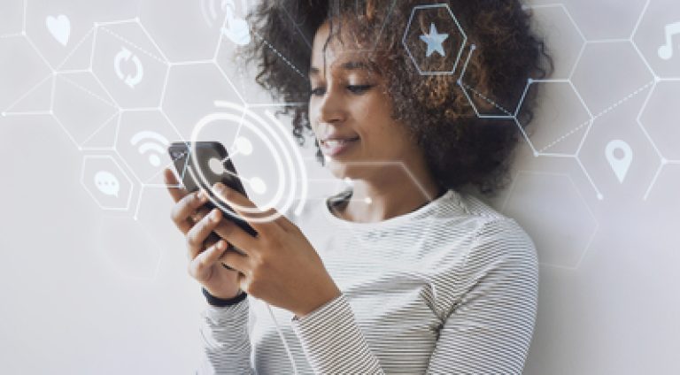 Cheerful black woman texting on her phone