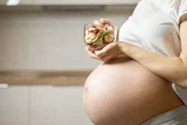 pregnant-woman-hands-holding-delicious-salad